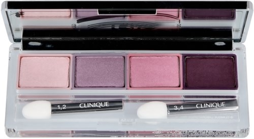 A makeup palette with four purple and pink eyeshadows and two small brushes labeled Clinique.
