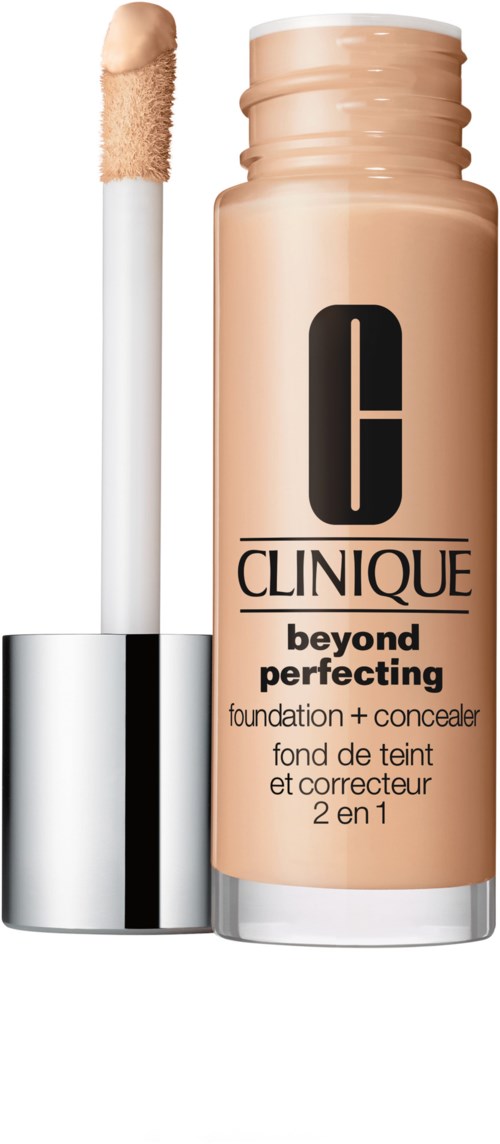 A beige makeup bottle with a black Clinique logo, and a sponge applicator beside it.