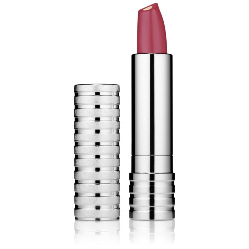 En silver läppstiftstift med rosa läppstift ovanpå, bredvid en stapel av liknande stift.