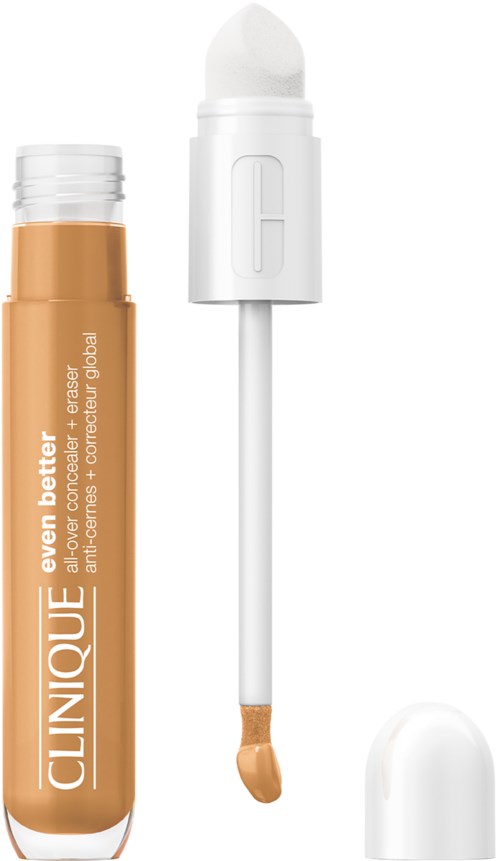 En beige-färgad flytande concealerstift med vit lock och en applikator med svampspets.