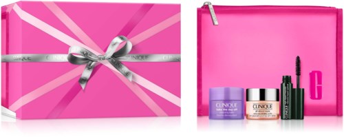 Skønhedsgaveæske i pink med sølvbånd, indeholder hudpleje- og makeupprodukter samt en pink taske.
