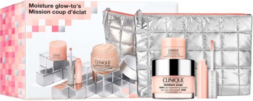 Beauty products include jars, tubes, and a silver bag, all in pink and silver colors, arranged attractively.