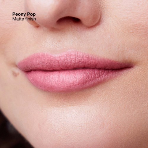 Close-up of lips with soft pink lipstick and slight matte finish, showing smooth skin and natural look.