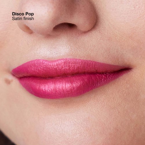Close-up of lips with pink lipstick, showing a smooth satin finish. Part of nose visible.