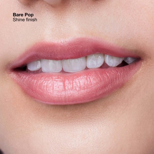 Close-up of lips and teeth, showing a smile with shiny, white teeth and pink lips.