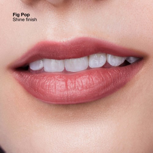 A close-up of lips with shiny, natural-looking pink lipstick, showing a gentle smile and white teeth.
