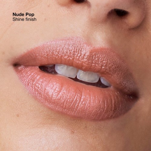 Close-up of lips with soft, shiny nude pink lipstick, slightly parted showing teeth, and skin with smooth texture.