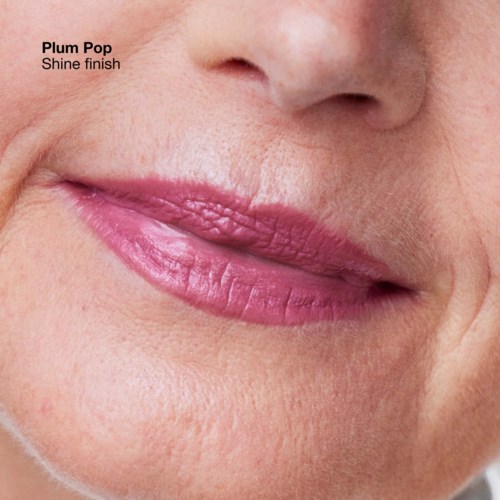 A close-up of lips with pink lipstick labeled 'Plum Pop Shine finish' on skin with visible wrinkles and pores.