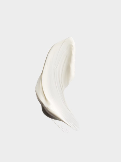 Ett vitt kräm- eller lotiontving på en vit bakgrund.