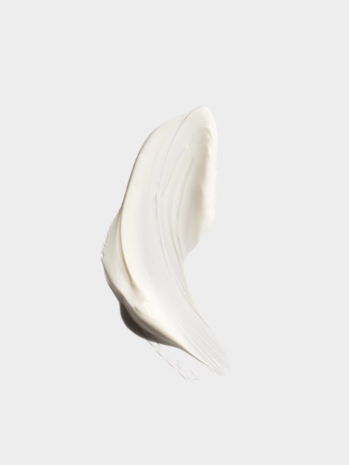 En virvel av vit kräm eller lotion på en ljus bakgrund.