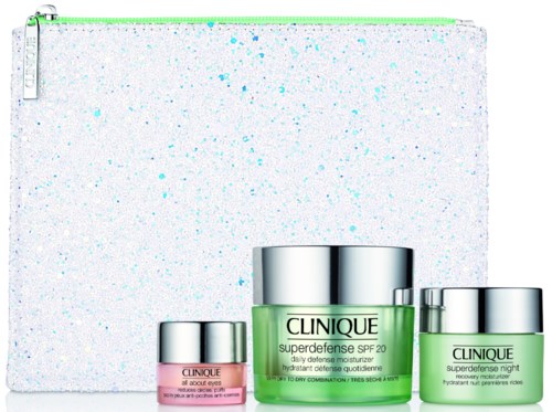 En serie av hudvårdsprodukter, inklusive krämer och moisturizers, med en vitt splashbakgrund och grön dragkedjefodral.