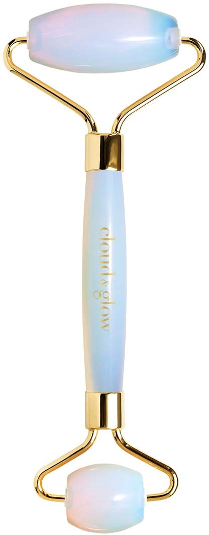 A skincare tool with two white, oval-shaped massage rollers, gold accents, and a light blue handle labeled 'derma flow'.