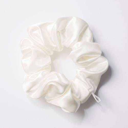 A white satin scrunchie with a glossy, smooth fabric and a small bow detail.