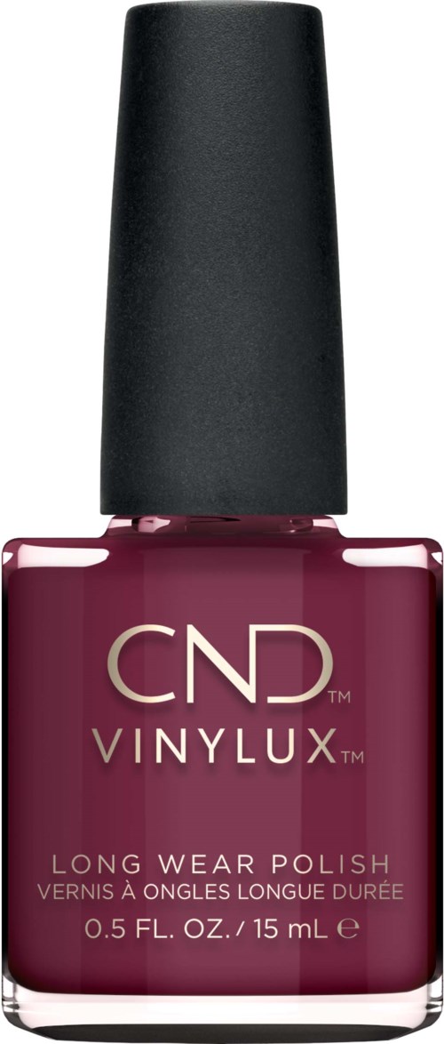 Een flesje donkerroze nagellak met een zwarte dop, gemarkeerd 'CND VINYLUX LONG WEAR POLISH'.
