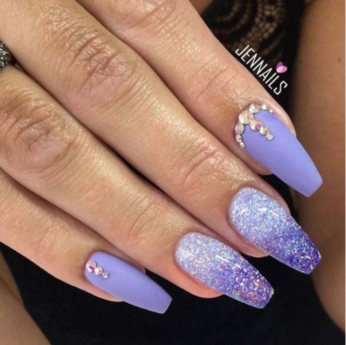 Nagellack med lila och glitter, dekorerad med små rhinstenen och blanka designer.