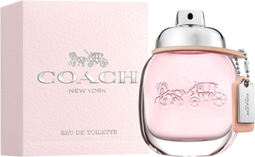 Butelka perfum Coach New York w różowym kolorze z srebrnym korkiem i różowym etui obok różowego pudełka.