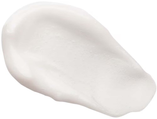 En vit, slät, oval form av vätska eller kräm på svart bakgrund.
