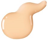 En beige, förlängd klump med liten svans, glänsande och slät yta, liknar en färgdroppe eller mjuk lera.