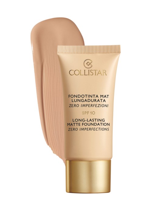 En tub med matt foundation med SPF 10, är krämfärgad med guldlock, och en klick av foundation.
