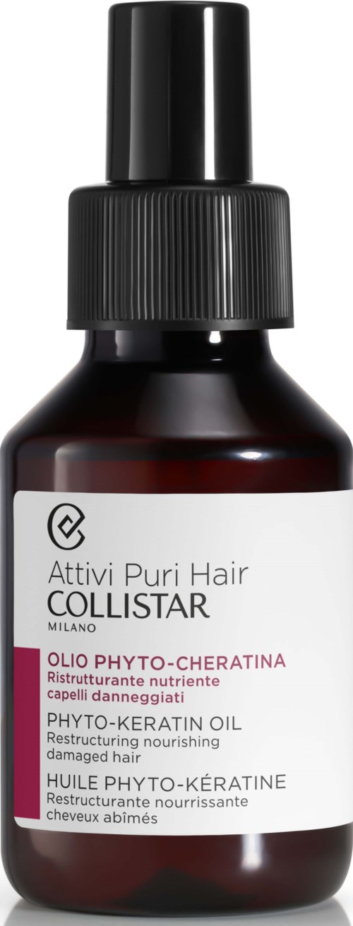 Eine kleine braune Flasche mit schwarzem Sprühkopf, beschriftet mit Produktdetails in mehreren Sprachen für Haarpflege.