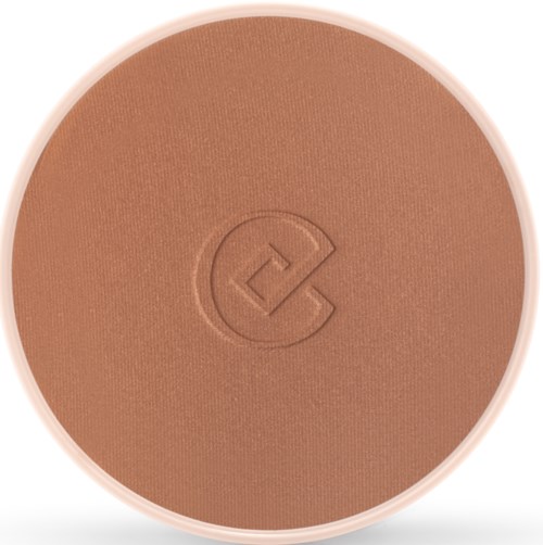 En runt makeupprodukt med en glad ansiktslogga i mitten.