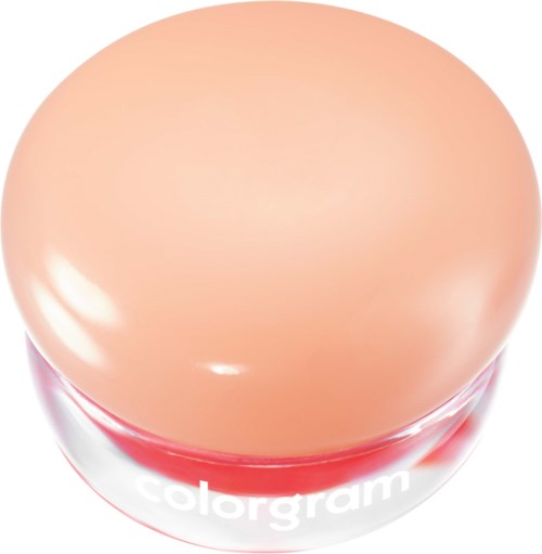 Een ronde make-upverpakking met het label colorgam, met een perzikkleurige deksel en een doorzichtige onderkant die rood binnenin toont.