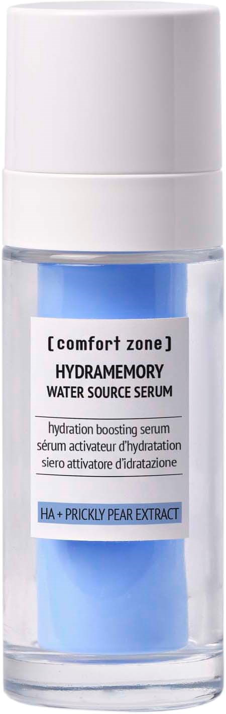 A clear bottle holds blue serum with white and black labels, mentioning hydration and pear extract.