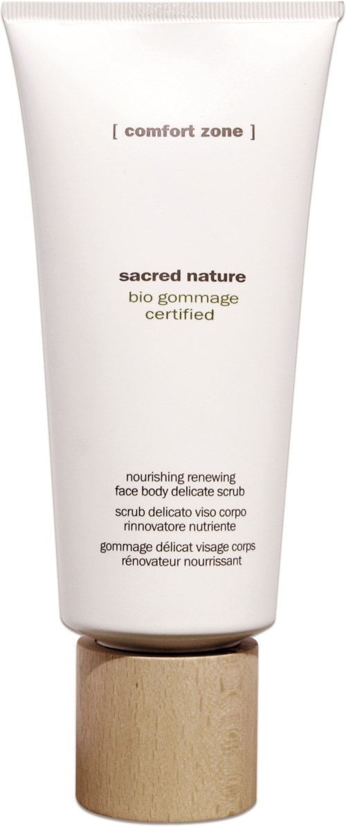 En vit tub med en träkork, märkt 'sacred nature' och 'bio gommage', indikerar en närande ansiktsskrubb.