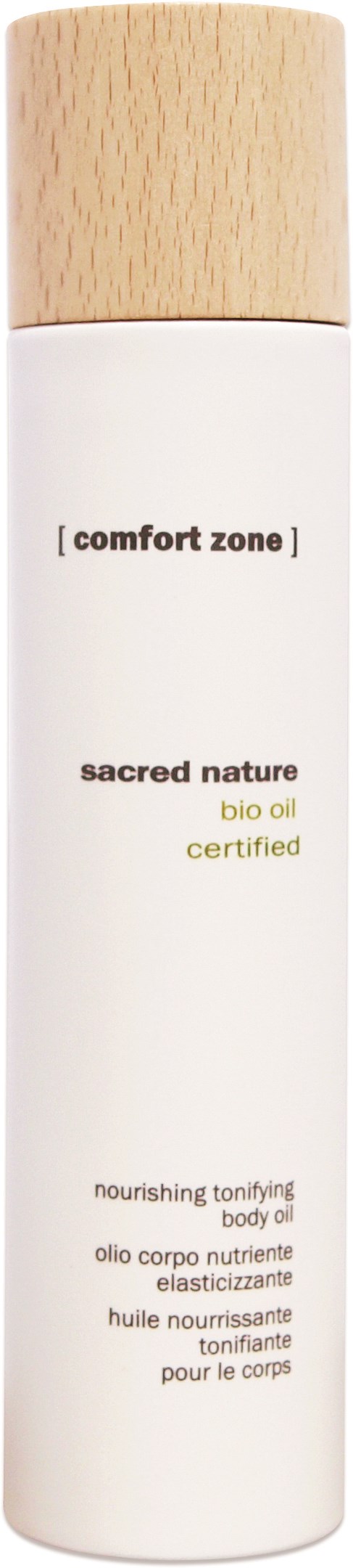 En vit flaska med ett ljus trälock, märkt "comfort zone sacred nature bio oil" och fler produktdetaljer.