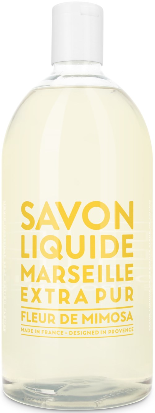 En transparent flaska med vit lock, innehållande tvålen med gul text som heter Marseille extra pure mimosa doft.