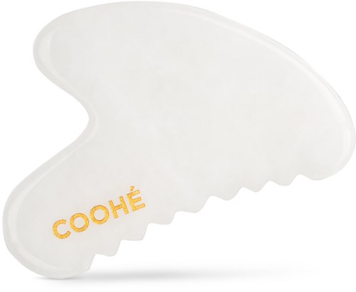 Ett vitt hårklämma med ordet 'COOHÉ' i guld. Klämman har en skrovlig kant.