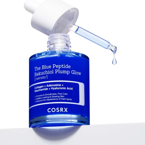 Blue serum bottle with dropper, label reads The Blue Peptide Bakuchiol Plump Glow, skincare ingredients listed, clear drop of serum.