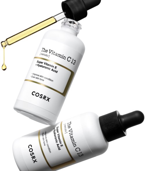 En hudvårdsserumflaska märkt med vitamin C3 och hyaluronsyra, med en pipett som släpper ut ett droppe olja.