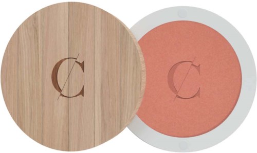 A round wooden object and a circular orange-red pad with similar symbols on them.