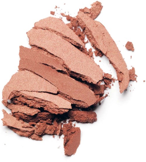 Krossad makeup puder i bruna nyanser, spridd på en vit bakgrund.