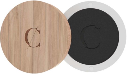Two round objects, one wood-colored and one black, with a letter 'C' in the center, stacked together.