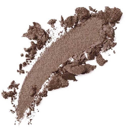 A smear of brown powder, likely makeup or eyeshadow, spread out with some scattered pieces around.