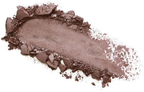 Powdered brown makeup or eyeshadow with shown debris and smooth section.