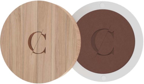 Round wooden and brown objects with a letter C cut out in the center. They look like coasters or lids.