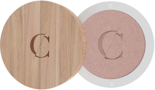 A compact with a pink shimmery powder. Wooden lid with a letter 'C' on it.