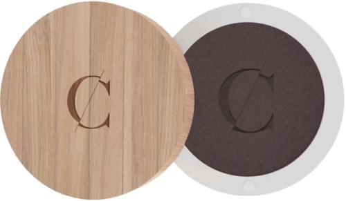 Two round objects, one wood-colored and one darker, have a stylized "C" in the center. They look like decorative items.
