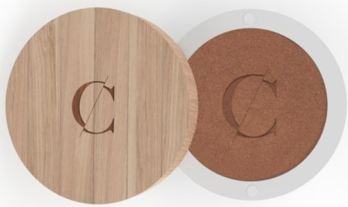 Two round items, one wooden and one brown, have similar logos with a C and arrow in the middle.
