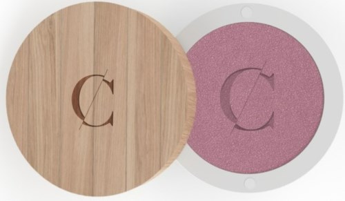 A wooden compact case with a pink cushion inside and a matching logo on top.