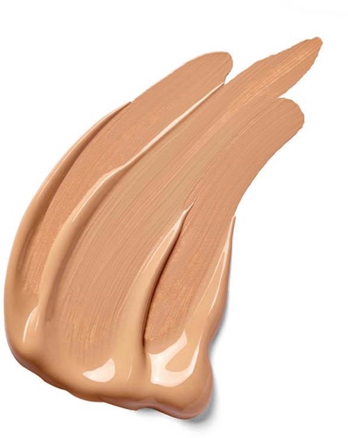 Een streek van lichtbruin vloeibaar make-up of foundation op een witte achtergrond.