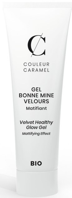 En vit tub med svart text, märkt 'COULEUR CARAMEL' och 'Velvet Healthy Glow Gel,' med en minimalistisk design.