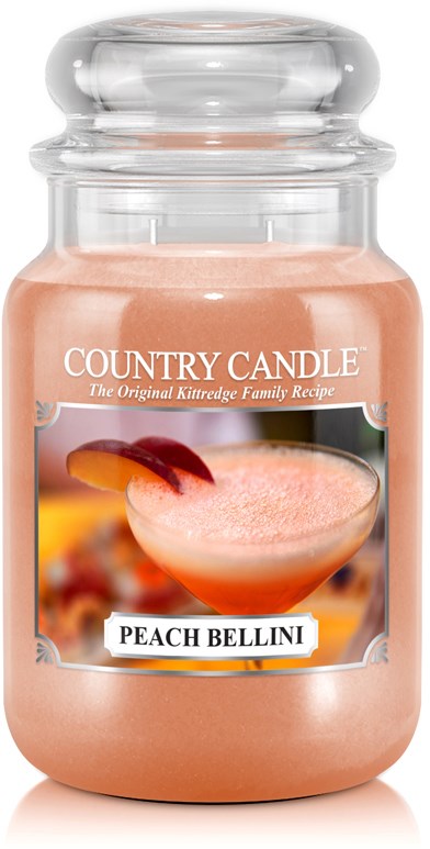 Et rosa lys i en glasskrukke merket "Country Candle" med en Peach Bellini-drink på etiketten.