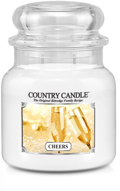 Ett tydligt glasburk märkt 'Country Candle' med ett foto av champagneglas och ordet 'Cheers'.