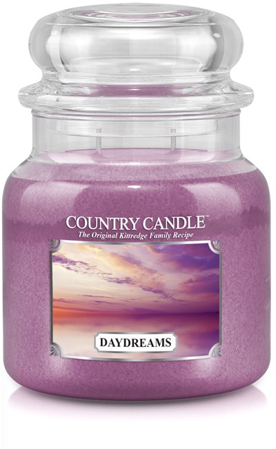 Lila doftljus i en genomskinlig glasburk med lock, märkt "DAYDREAMS". Burken är rund.