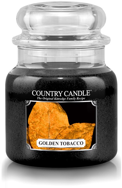 En svart ljushållare med klart lock, märkt 'Country Candle' och 'Golden Tobacco' med orange blad.
