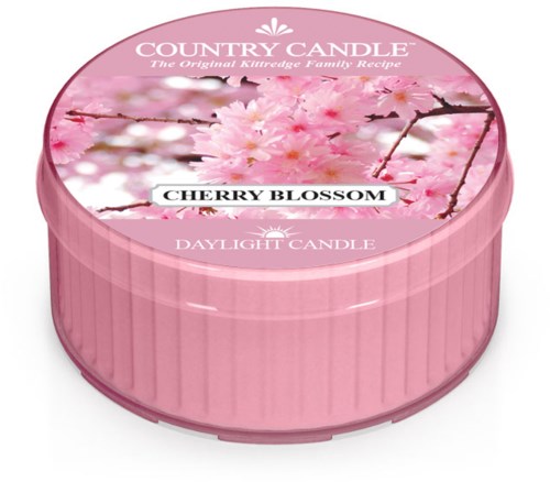 Rund rosa ljuskopp med körsbärsblommor på locket, märkt "Country Candle" och "Cherry Blossom."